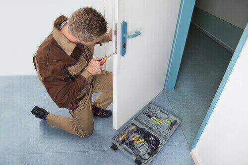 Locksmith working on lock